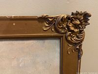 Close-up of upper right corner showing ornate gesso decoration and frame condition with some paint wear and nicks.