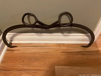 Photo showing the ice tongs fully opened, displaying curved gripping hooks and scissor handles.