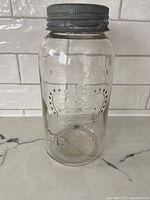 Front view of the vintage Mason jar showing embossed crown design and 'Made in Canada' text.
