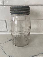 Front view of vintage Crown No.2 Mason canning jar with embossed crown logo and metal lid.