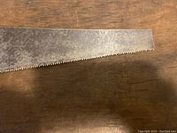 Close-up of the saw blade teeth showing fine teeth and metal surface condition