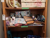 Shelf with assorted makeup pouches, boxes, and personal care items