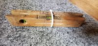 Photo shows two vintage wooden levels stacked and secured with a white plastic zip tie, displaying the end and side view clearly showing wooden construction and glass bubble vial.