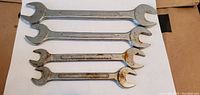 Four Barcalo-Buffalo open-end wrenches arranged on a white background showing size markings and condition.