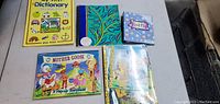 Six children's books displayed on a table, showing front covers.