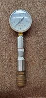 Full length photo of the 8 inch USG pressure gauge showing metal body and brass fittings