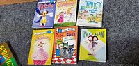 Front covers of six children's early reader books on carpeted floor.