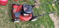 Side angle of Toro Recycler lawn mower showing engine and wheels