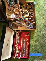Box of assorted bracelets including plastic bangles and braided cord bracelets