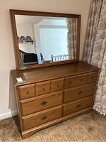 Full front view of the dresser with attached mirror showing drawer configuration and overall condition