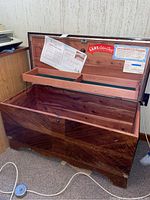 Open Lane Cedar Chest showing felt-lined compartment on lid and large storage space inside with some wear on wood surfaces.