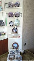 Overall view of shelves with plates and Swarovski figurines