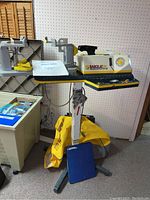 Full view of Babolat VS racket stringing machine with binder and bag at base