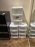 Three Gracious Living plastic storage units stacked and side by side, showing three drawers each, clear plastic with white trim.