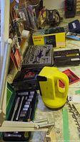 Tools and kits arranged on a table, including Bosch planer box, ratchet sets, and yellow handled cordless cutters