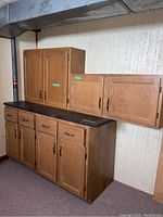 Full view of the three-piece cabinet set including upper and lower cabinets with doors, drawers, and countertop.