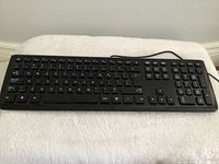 Photo of a black full-sized wired keyboard with numeric keypad and function keys.