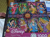 Disney Princess collage puzzle box showing stained glass style artwork of Disney princesses and puzzle count of 1000 pieces.