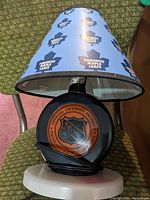 Table lamp with Toronto Maple Leafs shade and NHL licensed product base, corded power supply attached