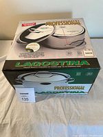Box with Lagostina Professional branding and image showing stockpot and lid, price tag visible.