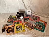 View of the View-Master viewer and all 10 picture reels laid out showing titles and images.