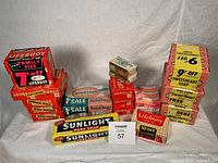 Multiple stacks of vintage soap bars including Lifebuoy, Sweet Heart, and Sunlight brands with promotional labels on packaging.