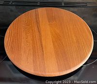 Top view showing circular teak wood Lazy Susan with smooth, polished surface and visible wood grain.