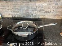 Photo of Lagostino large saucepan with glass lid on stove.