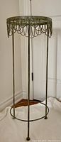 Photo of the full plant stand showing height, legs, and circular top edge.