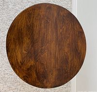 Top-down view of the round wooden table top showing smooth surface and wood grain.