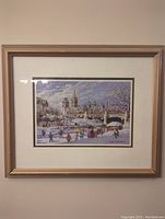 Front view of the framed print showing the winter skateway scene with people skating and background buildings.