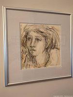 Framed watercolor portrait of a woman with soft muted tones, showing the entire artwork and frame.