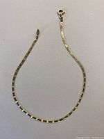 Full view of the rectangular snake chain bracelet laid out flat showing length and chain style.