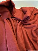 Close-up of burnt cinnamon raw silk fabric showing texture and color.