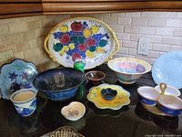 Overview of the collection of assorted serverware on kitchen counter including tray, bowls, and plates