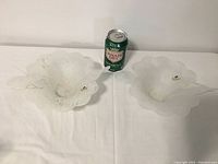 Pair of opaque white Murano glass bowls with paper label Arte Murano marked, placed side by side with a soda can for scale.