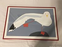 Frontal view of framed print showing entire artwork and red metal frame