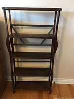Front view of vintage solid wood open shelf bookcase with five shelves, showing overall structure and design.