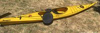 Side profile of yellow sea kayak with deck, hatch covers and seat