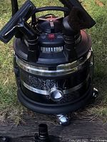 Front view of Filter Queen Majestic canister vacuum with decorative stainless steel body and black top