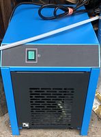 Front view showing power switch and ventilation panel on blue body of compressed air dryer.