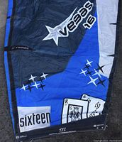 Blue and black section of Vegas 16 kite showing graphic details including white stars and a playing card king logo, labeled "sixteen"