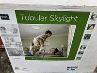 Box showing ODL Tubular Skylight branding and promotional image with product installed