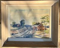 Frontal view of original watercolor painting depicting rustic farm scene framed in a natural wood frame with mat and glass.