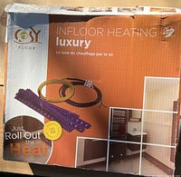 Top front of the box showing brand Cosy Floor and product type Luxury In-floor Heating with heating cable and plastic mats images