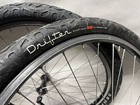 Close-up of Serfas Drifter tire branding and tread pattern showing size 26x2.0 and flat protection indicator.
