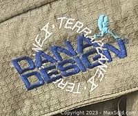 Close-up of Dana Design Terraplane X logo embroidered in blue on olive fabric