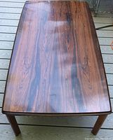 Tabletop view on deck showing rosewood veneer pattern and finish.