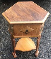 Full view of the vintage smokers stand showing hexagonal wooden top, three pull drawers with metal ring handles, detailed woodwork, and bottom shelf.