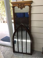 Photo of both mirrors leaning against the wall, showing sizes and styles.